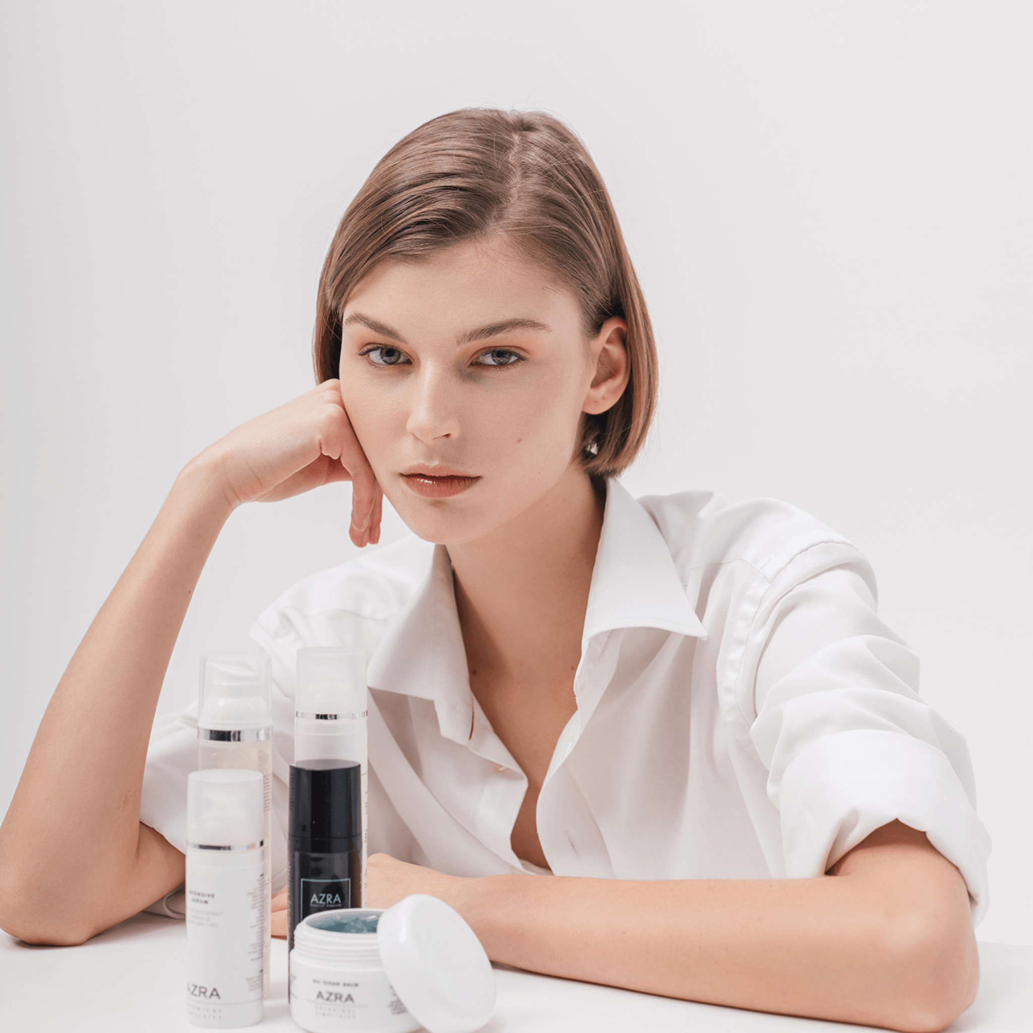 Woman with a part of Azra Botanical Simpilicity Skincare collection